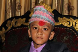 A Nepali Kid Wearing a Dhaka Topi During Dashain
