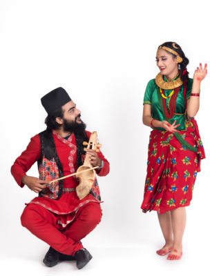 nepali-girl-dancing-while-man-plays-sarangi-sitting-on-muda-0ppg160be